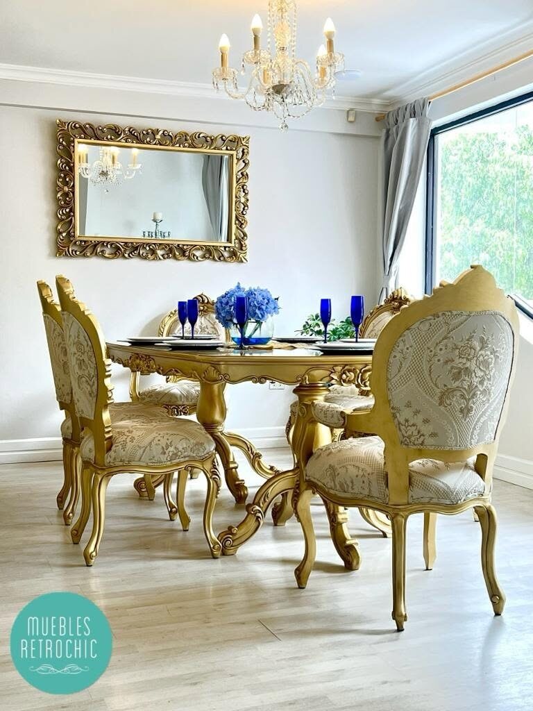 Gilded and ivory Baroque dining room beside a carved mirror