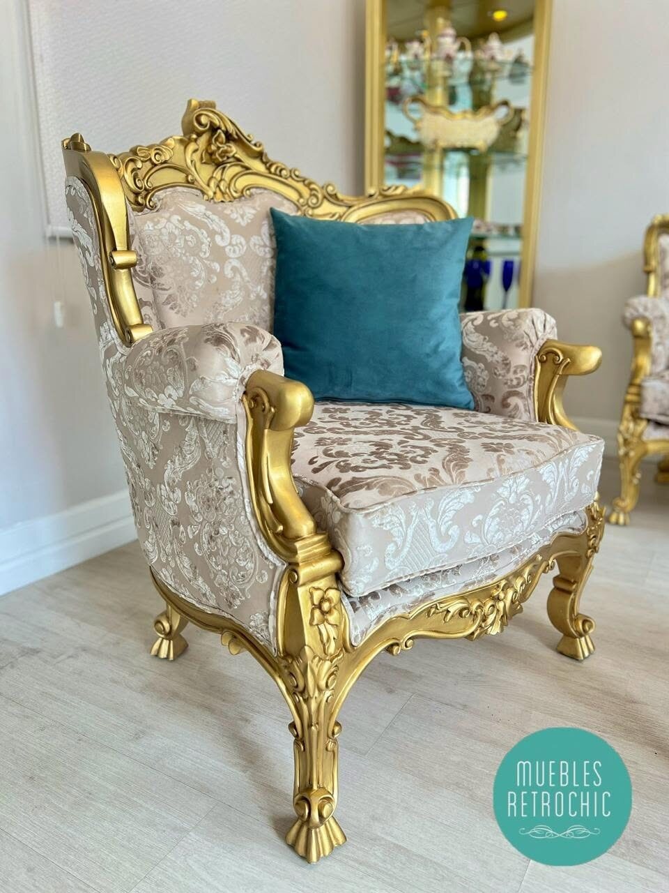 Detail of a gold Marquise armchair with blue upholstery