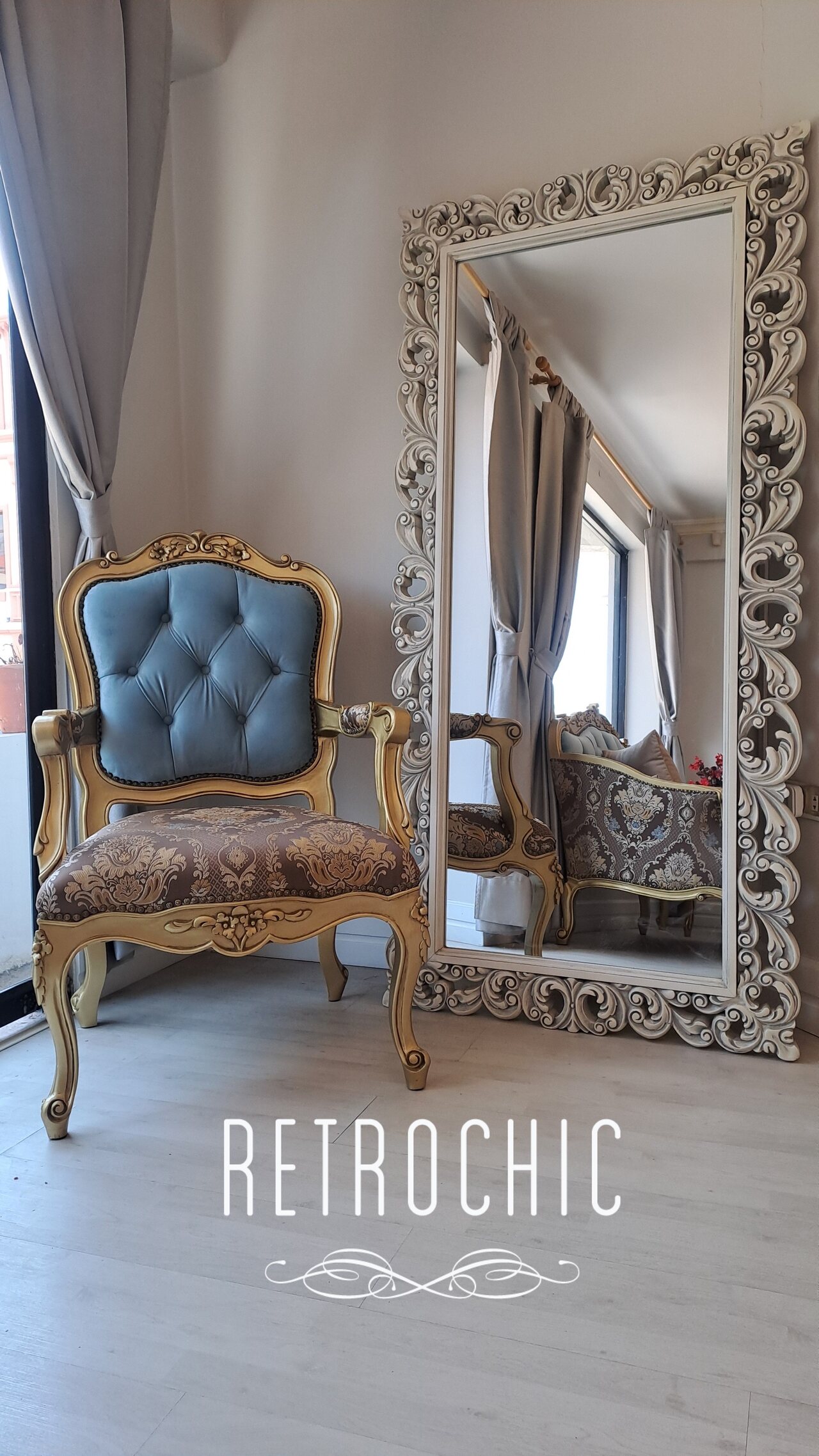 Gold-toned Marquise armchair beside a silver-toned Versailles mirror