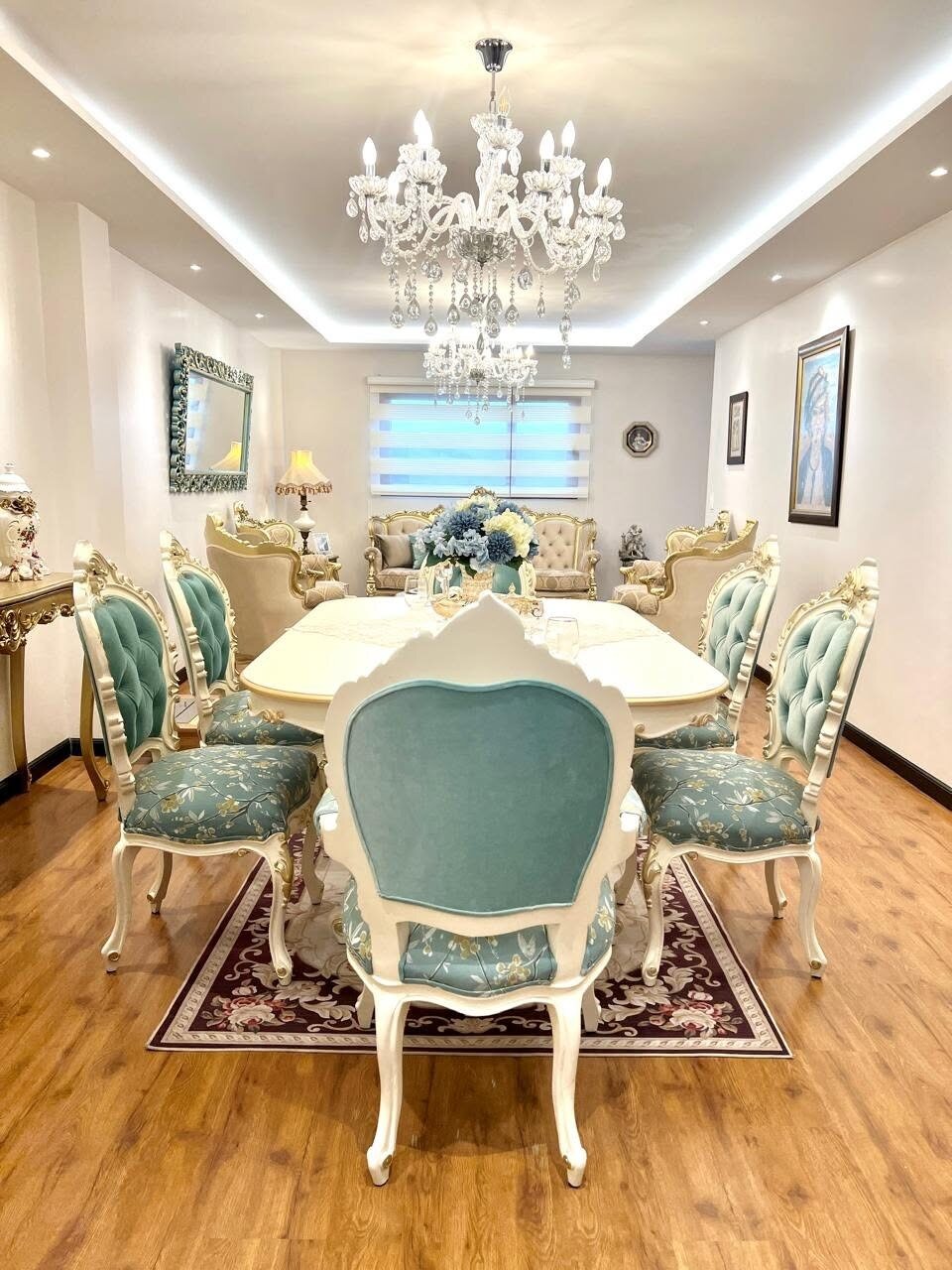 Turquoise Marquise dining room with a carved table and medallion chairs