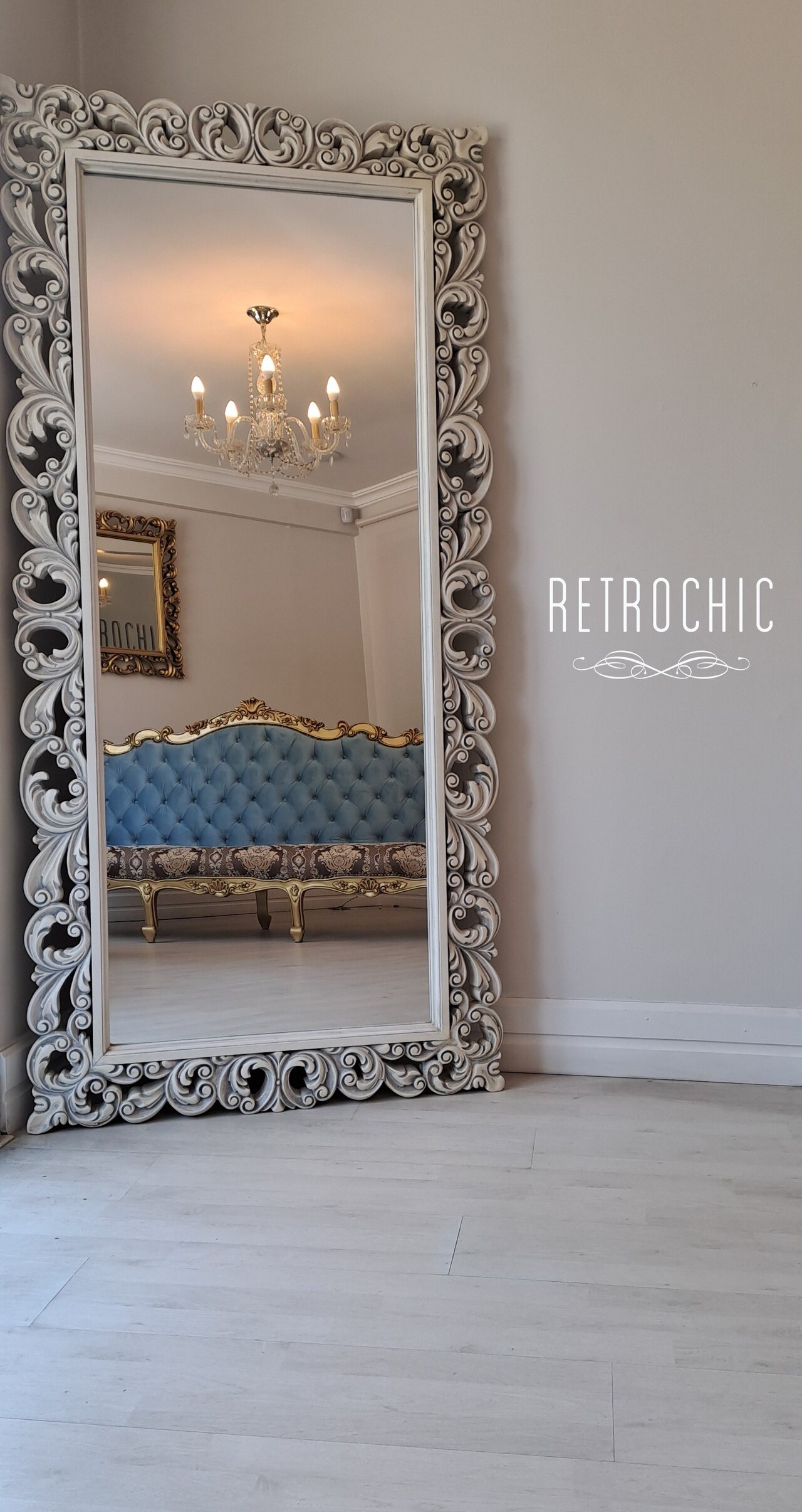 Versailles mirror reflecting a Marquise triple sofa